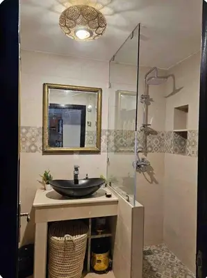 a bathroom with a sink and a glass shower at Atlas golf resort in Marrakech